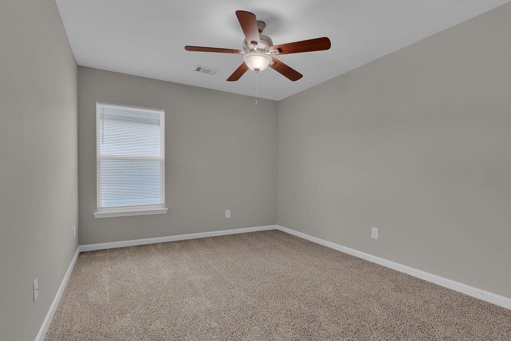 1978 Cutleaf Creek Road Southeast Grayson, GA 30017 - Photo 27 of 38 an empty room with a window and a ceiling fan
