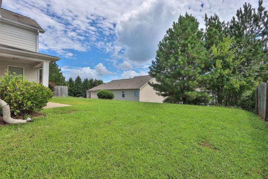 1978 Cutleaf Creek Road Southeast Grayson, GA 30017 - Photo 36 of 38 a view of a house with yard and a garden