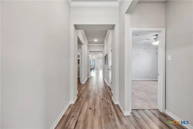 a view of a hallway with wooden floor