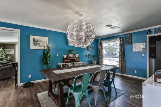 700 Sherri Street Ridgecrest, CA 93555 - Photo 14 of 34 a view of a dining room with furniture and wooden floor