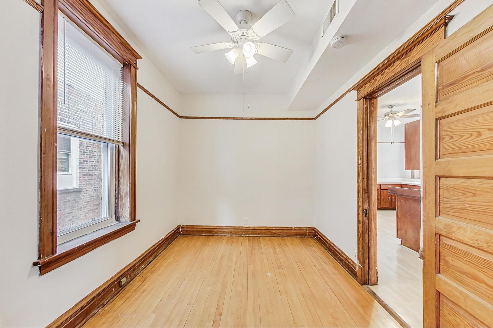1646 West Byron Street, Unit 3F Chicago, IL 60613 - Photo 21 of 30 a view of a room with wooden floor and a window