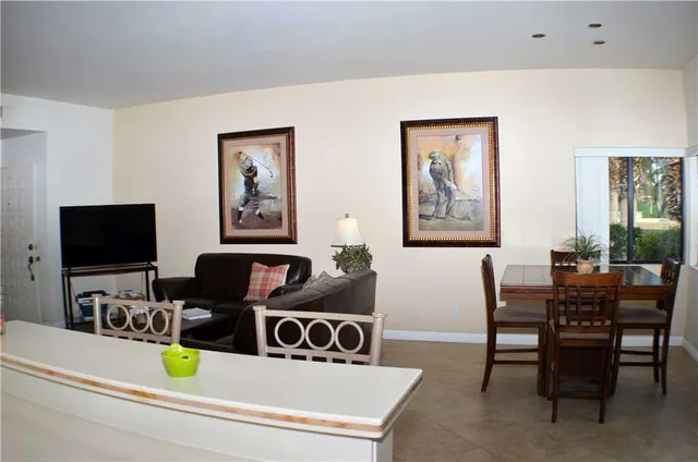 a view of a hallway with bathroom and mirror