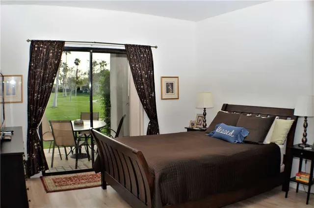 a bedroom with two beds and a lamp