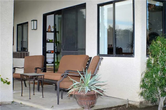 a view of a balcony with table and chairs