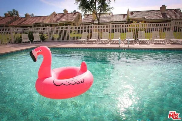 a view of a swimming pool with a backyard and slide