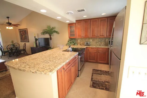 a kitchen with stainless steel appliances granite countertop a sink and a stove
