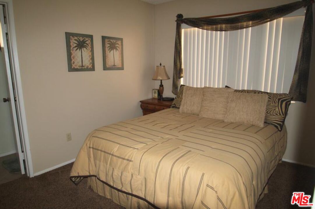 40420 Bay Hill Way Palm Desert, CA 92211 - Photo 6 of 12 a bedroom with a bed and a window