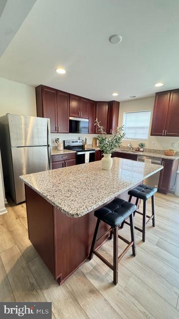 65 Chesterfield Road East Berlin, PA 17316 - Photo 16 of 32 a kitchen with stainless steel appliances granite countertop a table chairs sink refrigerator and microwave