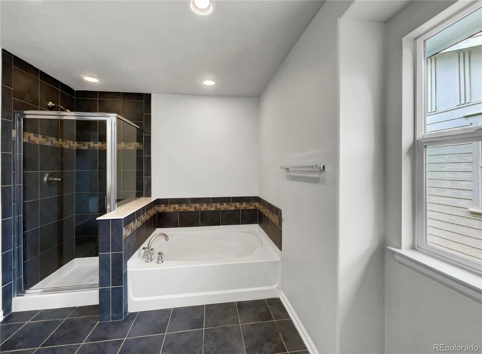 2380 Xanthia Way Denver, CO 80238 - Photo 16 of 19 a bathroom with a bathtub and a shower