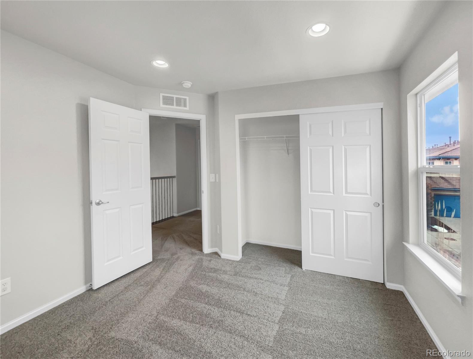 2380 Xanthia Way Denver, CO 80238 - Photo 5 of 19 an empty room with closet and windows