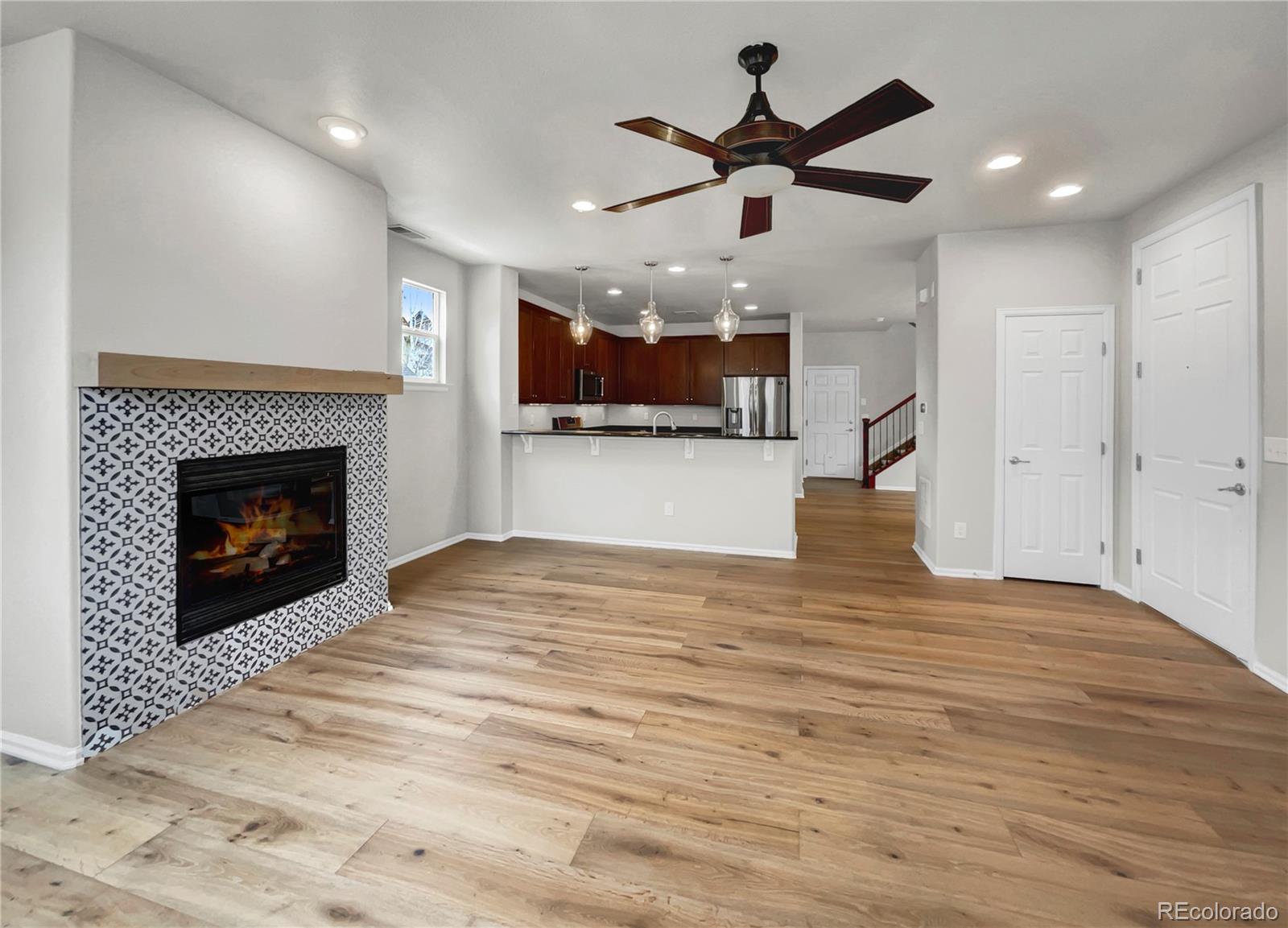 2380 Xanthia Way Denver, CO 80238 - Photo 6 of 19 a view of empty room with wooden floor and fireplace