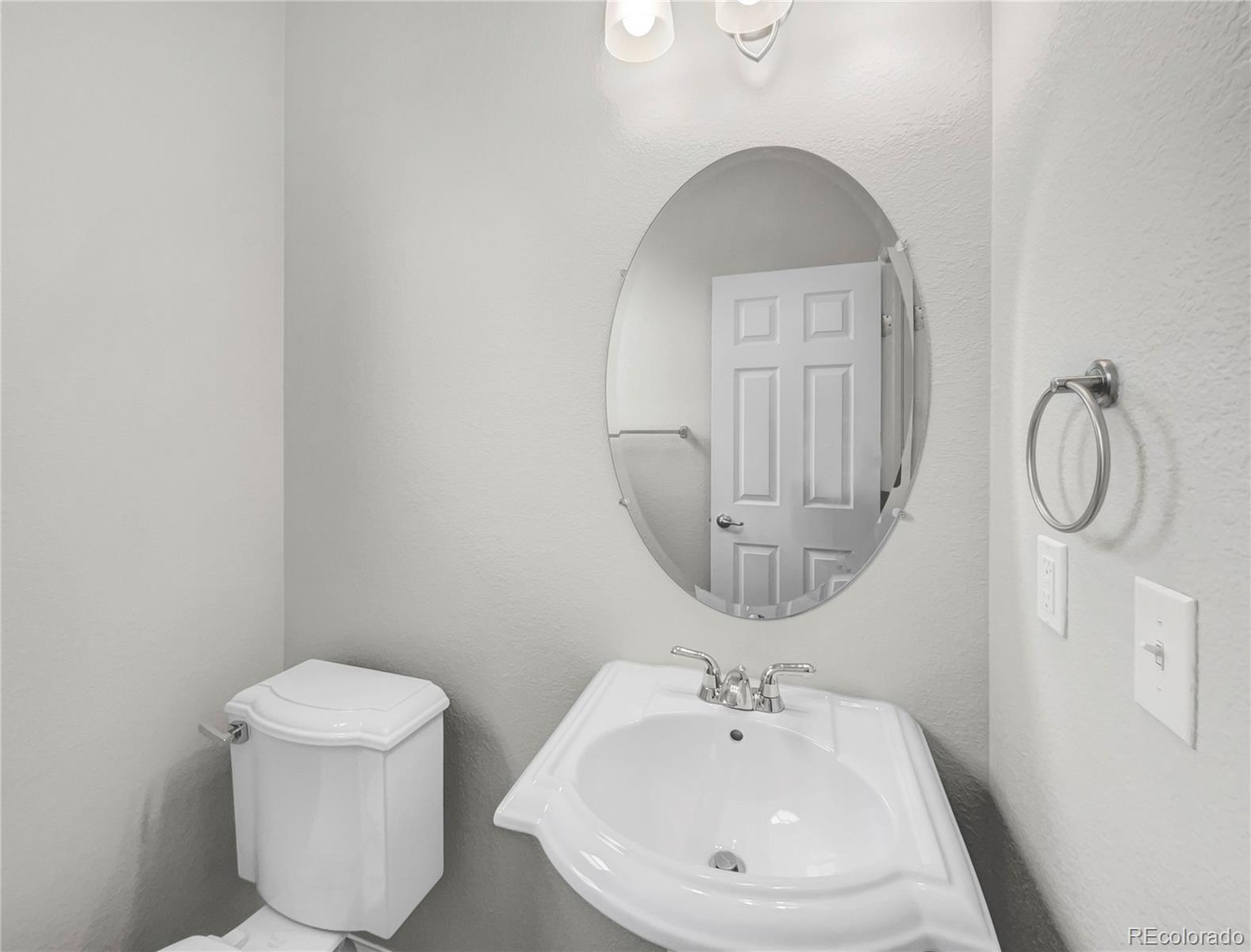 2380 Xanthia Way Denver, CO 80238 - Photo 9 of 19 a bathroom with a toilet sink and mirror