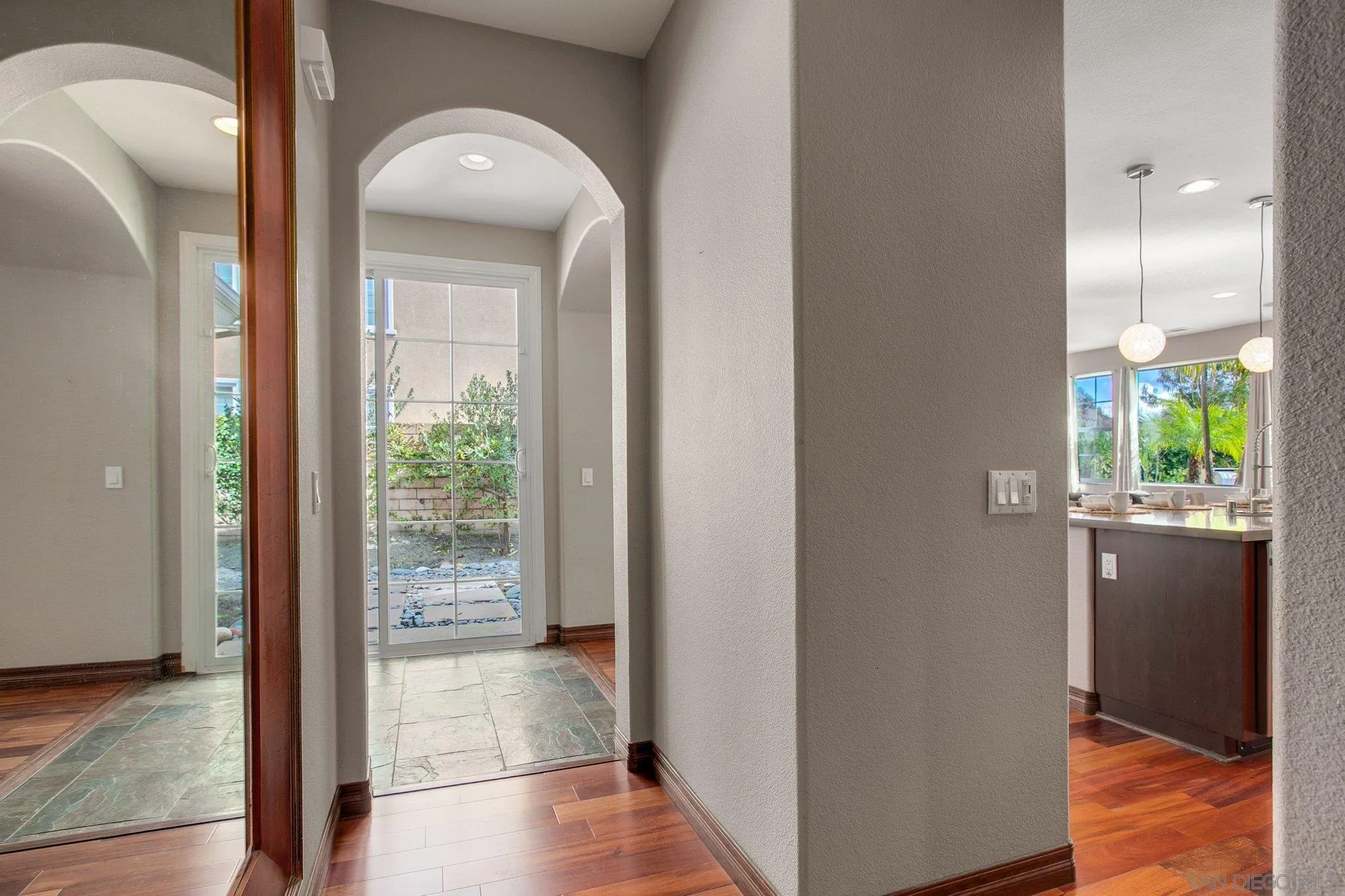 1104 Sagewood Drive Oceanside, CA 92056 - Photo 19 of 46 a view of a hallway with wooden floor and a bathroom