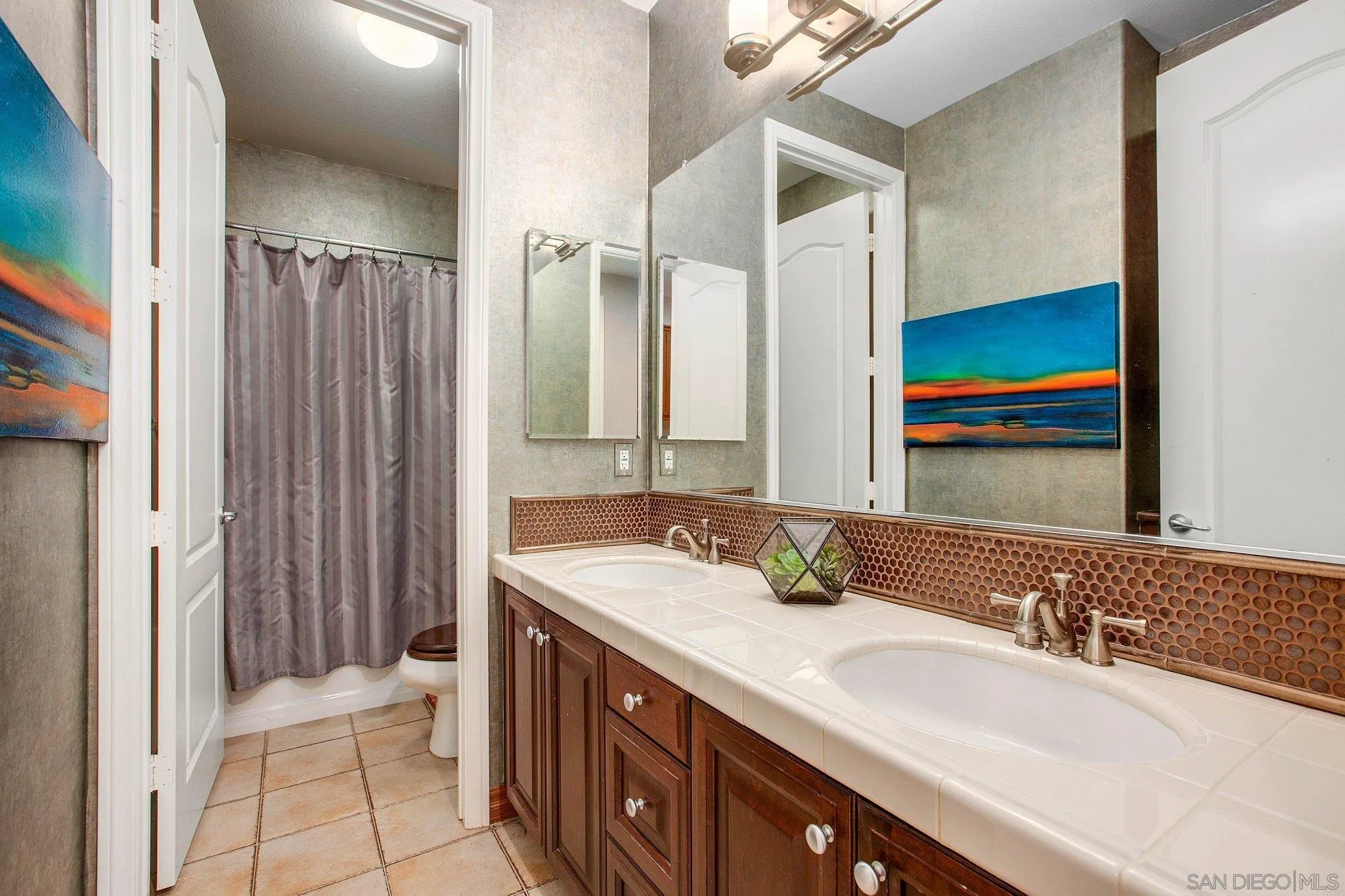 1104 Sagewood Drive Oceanside, CA 92056 - Photo 27 of 46 a bathroom with a double vanity sink and a mirror