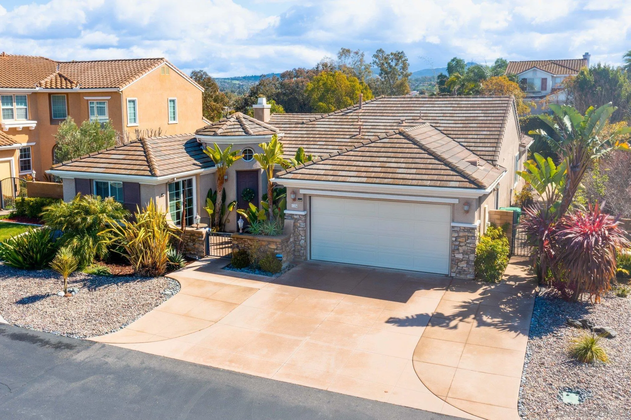 1104 Sagewood Drive Oceanside, CA 92056 - Photo 45 of 46 a view of a white house with many windows next to a road