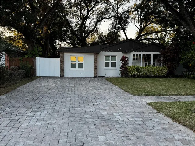 a house that has a tree in front of a house