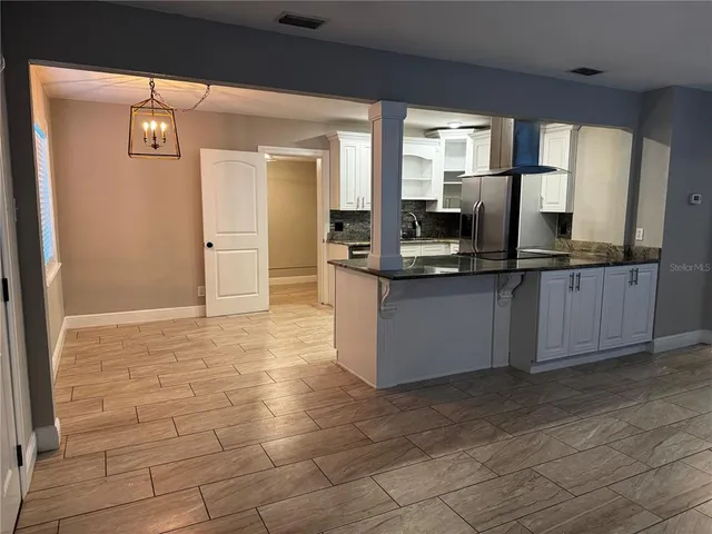 a kitchen with stainless steel appliances a sink stove and cabinets