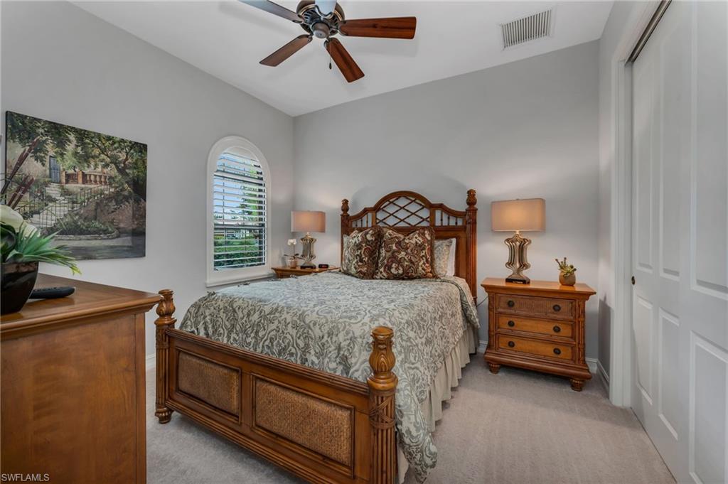 6714 Canwick Cove Circle Naples, FL 34113 - Photo 11 of 23 a bedroom with a bed and windows