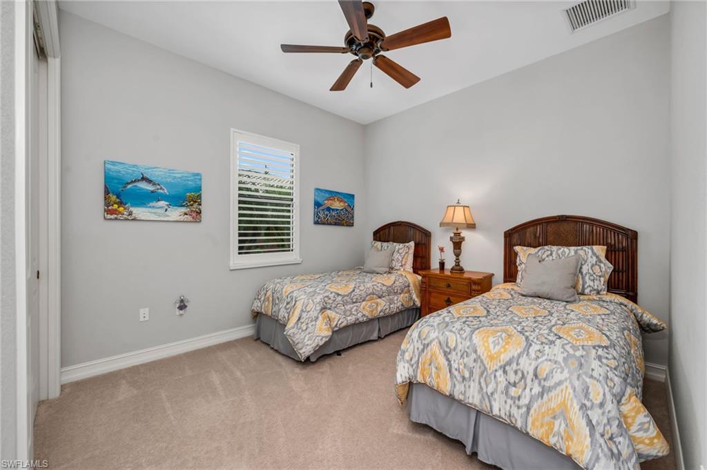 6714 Canwick Cove Circle Naples, FL 34113 - Photo 13 of 23 a bedroom with two beds and ceiling fan