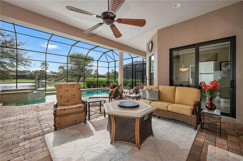 6714 Canwick Cove Circle Naples, FL 34113 - Photo 17 of 23 a living room with patio furniture and a floor to ceiling window