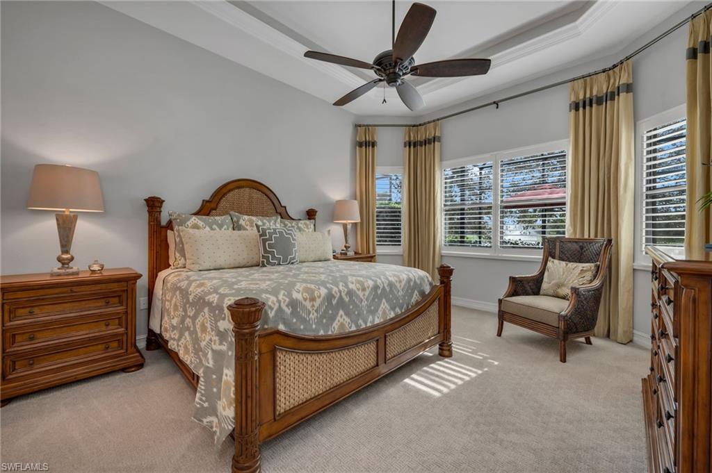 6714 Canwick Cove Circle Naples, FL 34113 - Photo 9 of 23 a bedroom with a bed a couch and a large window