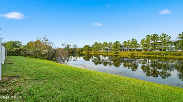 a view of a lake with houses in the back