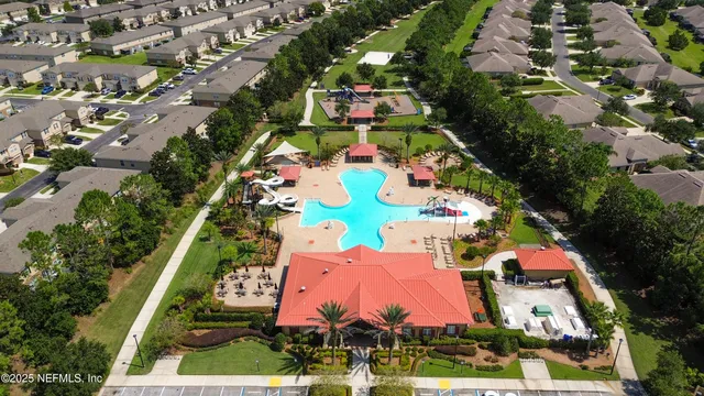 an aerial view of a house with a garden and swimming pool
