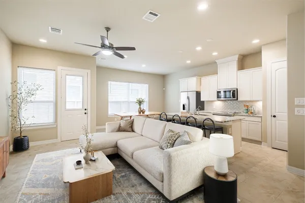 a living room with furniture and a large window