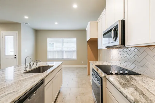 a kitchen that has a sink and a stove