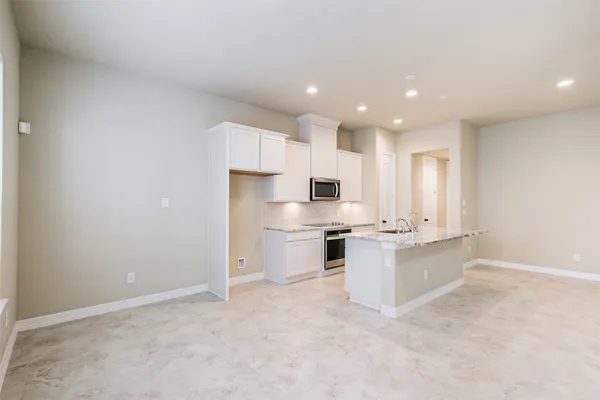 a kitchen with a stove a sink and a refrigerator