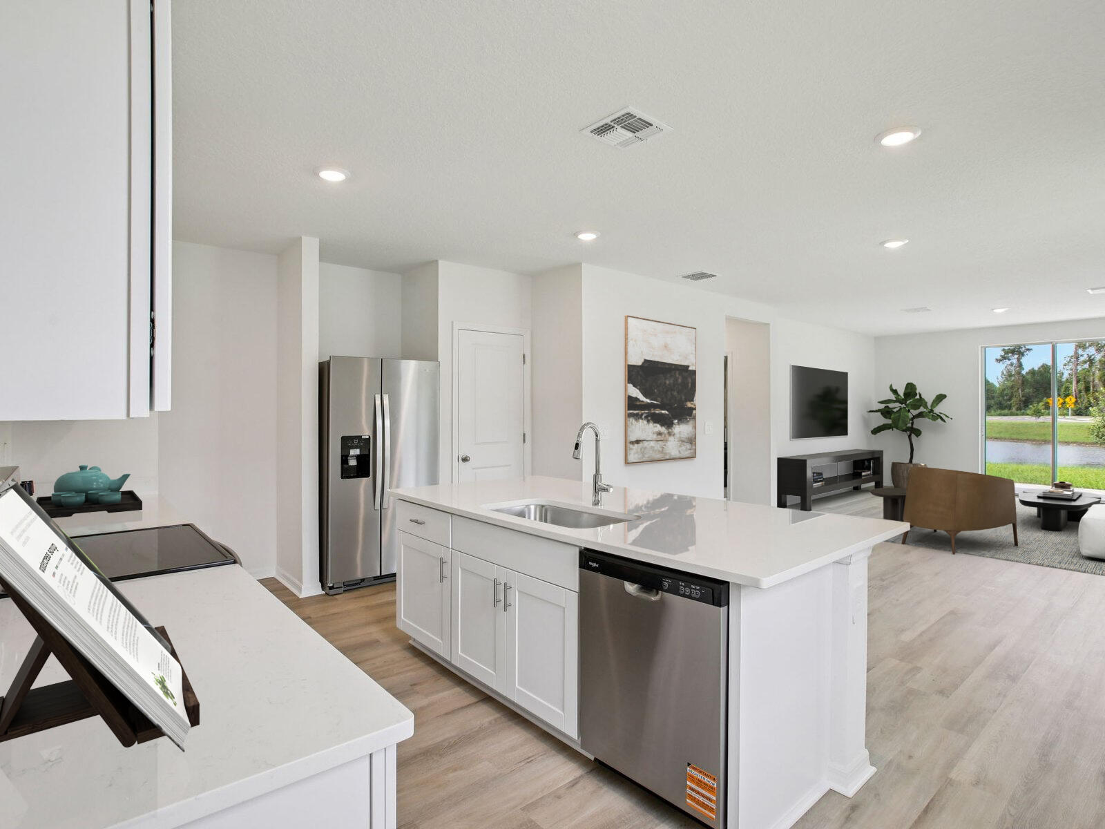 14314 Southwest New Dawn Road Indiantown, FL 34956 - Photo 10 of 18 a kitchen with stainless steel appliances kitchen island a sink dishwasher a refrigerator and a stove with wooden floor