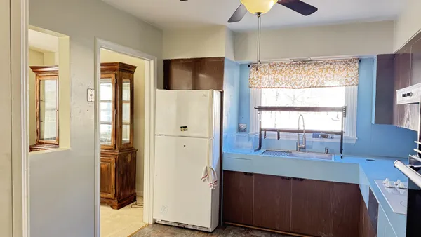 a kitchen with stainless steel appliances a refrigerator and a window
