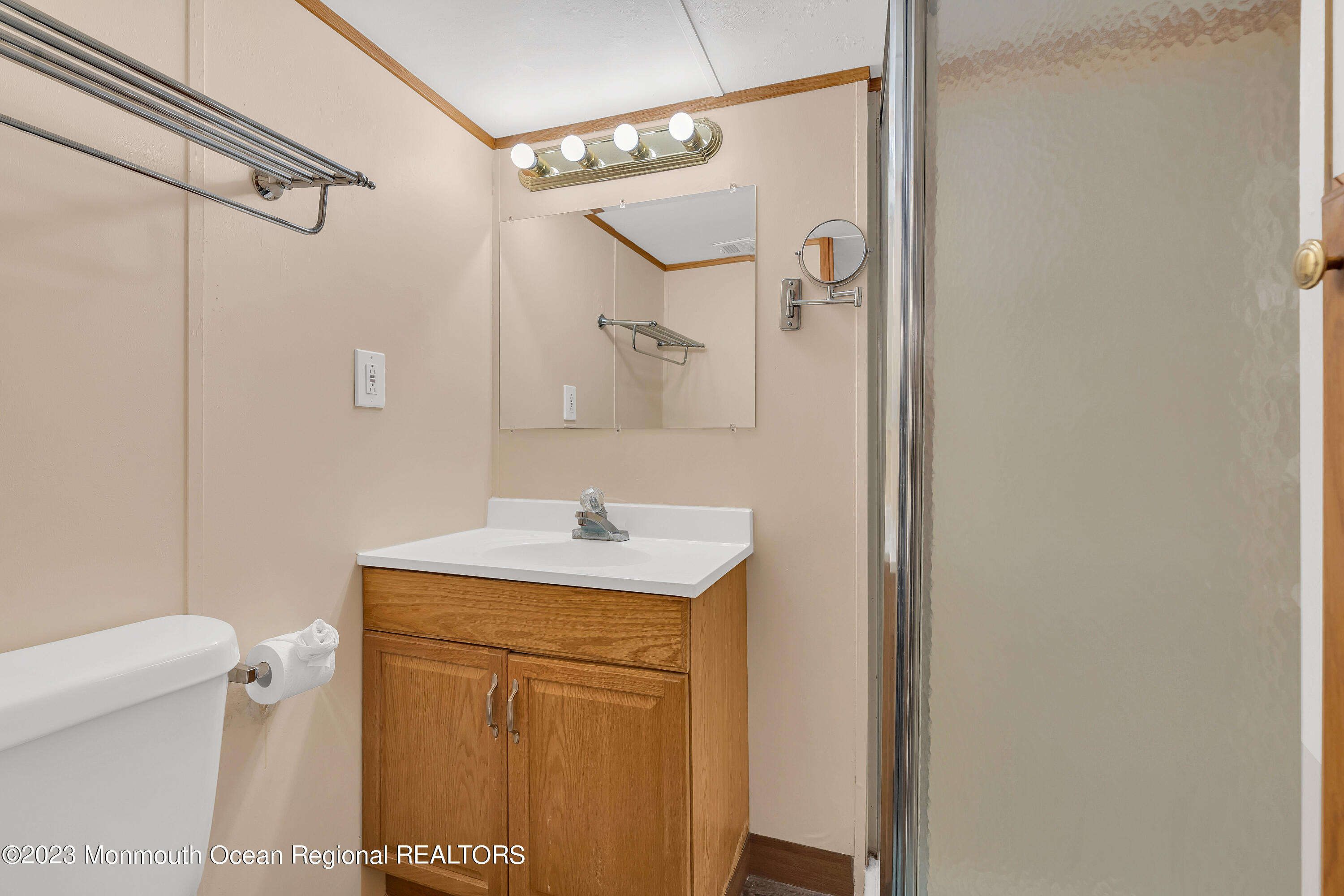 724 Monmouth Road, Unit 33 Cream Ridge, NJ 08514 - Photo 12 of 27 a bathroom with a granite countertop sink toilet and shower