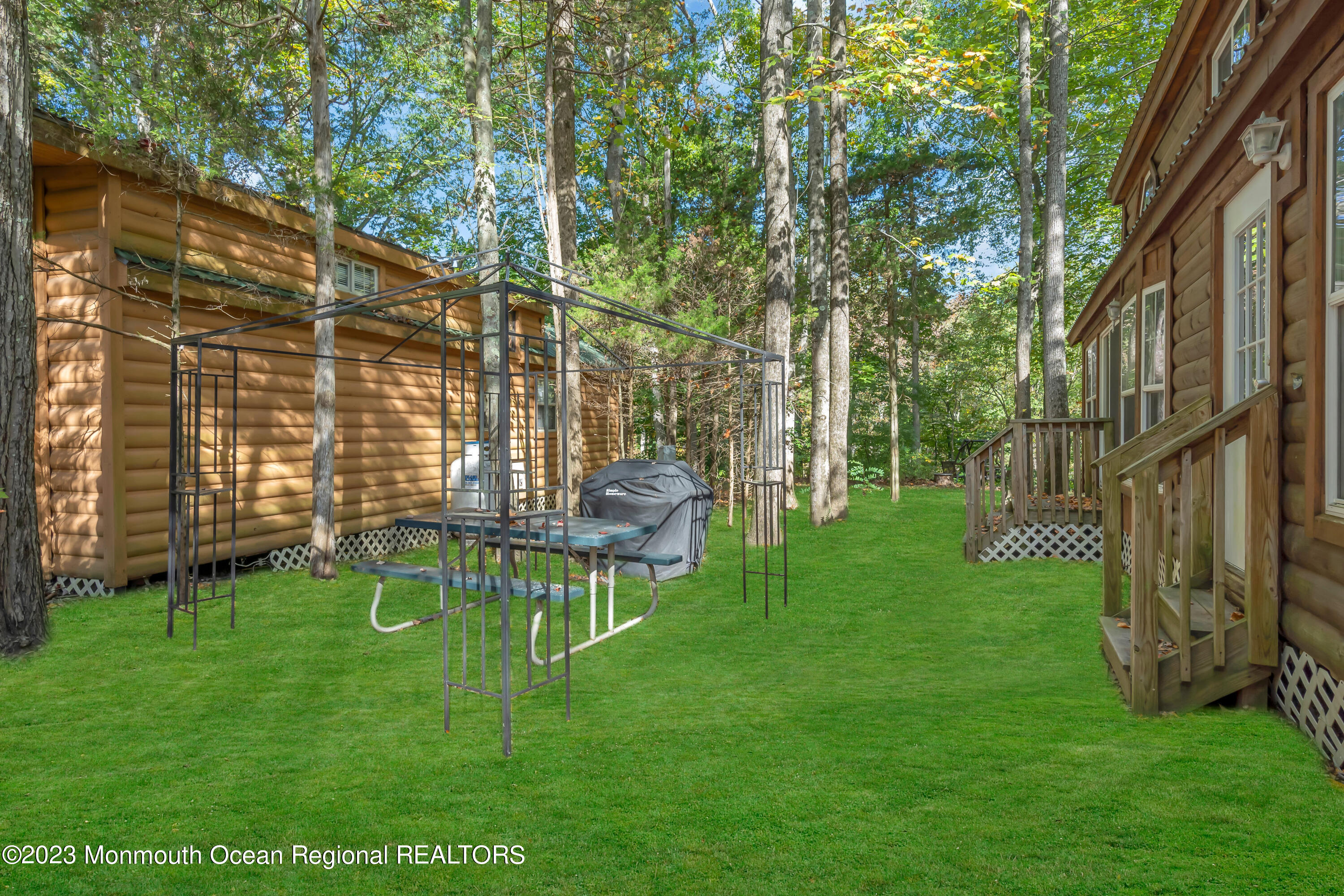 724 Monmouth Road, Unit 33 Cream Ridge, NJ 08514 - Photo 15 of 27 a view of a chair and table on the green field