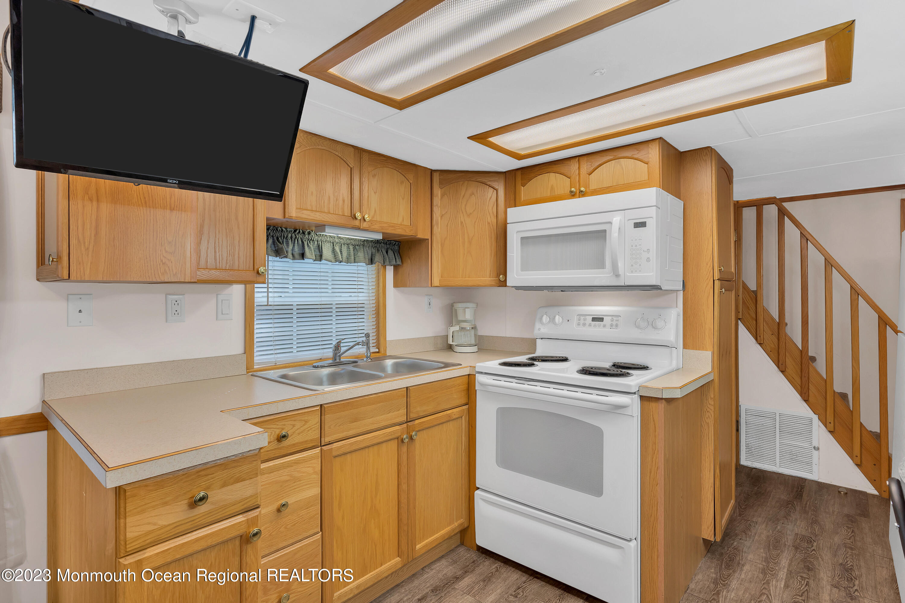 724 Monmouth Road, Unit 33 Cream Ridge, NJ 08514 - Photo 6 of 27 a kitchen with a stove cabinets and a sink