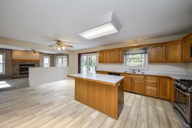 a kitchen with stainless steel appliances granite countertop wooden floors and sink