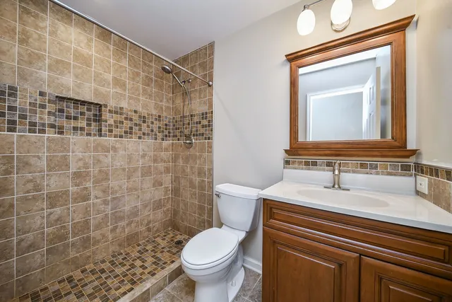 a bathroom with a sink toilet and shower