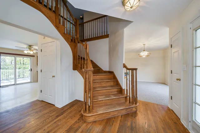 a view of entryway and hall with wooden floor