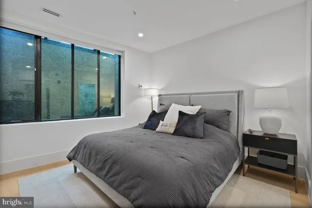 a bedroom with a large bed and a window