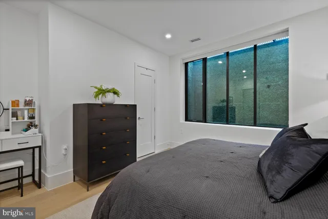 a bedroom with a bed and a dresser