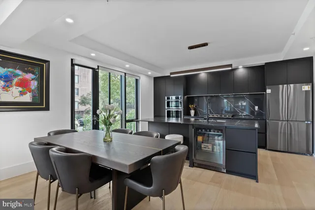 a kitchen with a table chairs and refrigerator