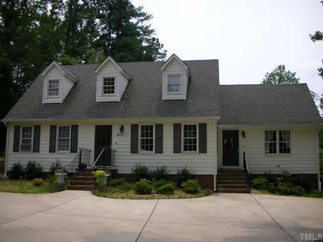 2813 Ashland Street Raleigh, NC 27608 - Photo 1 of 1 a view of a brick house with a yard and large windows