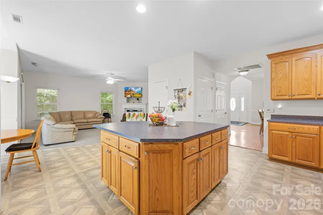 a large kitchen with stainless steel appliances a sink and cabinets
