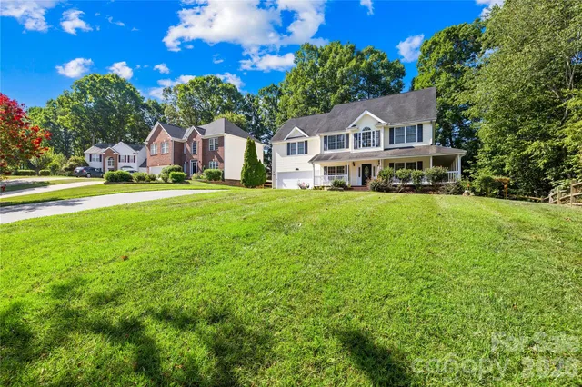 a front view of a house with a garden and porch
