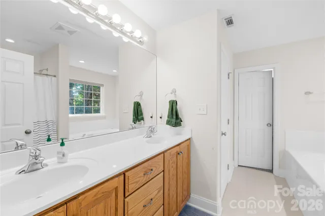 a spacious bedroom with a bed and a window