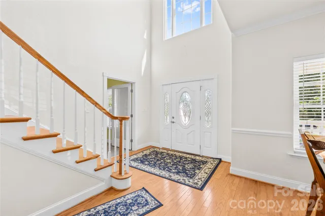 a view of entryway with wooden floor and stairs