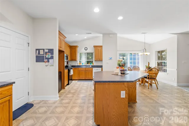 a view of kitchen with furniture and refrigerator