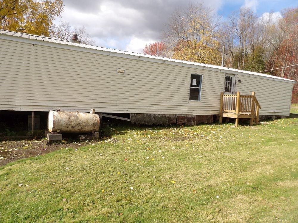 a view of a chair and tables in the backyard