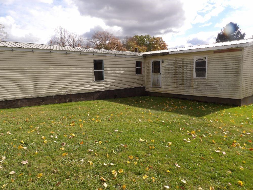 53 Donation Road Greenville, PA 16125 - Photo 11 of 11 a view of a backyard with plants and large tree