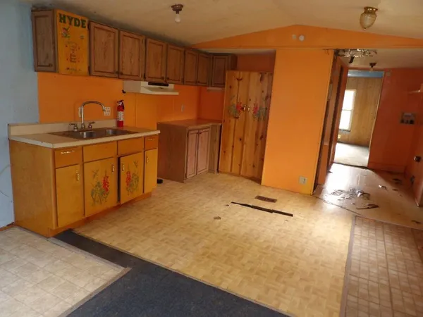 a kitchen with sink cabinets and appliances